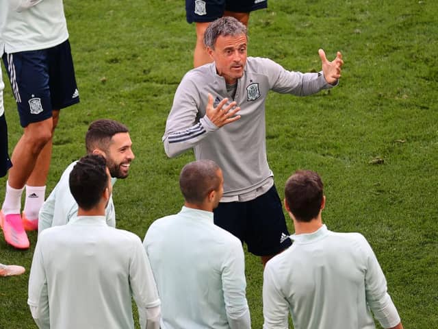 Spain head coach Luis Enrique interacts with his players during training. Photo by Wolfgang Rattay - Pool/Getty Images