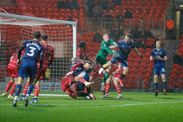 Goalmouth action in atrocious conditions during the Emirates FA Cup second round against Doncaster Rovers.