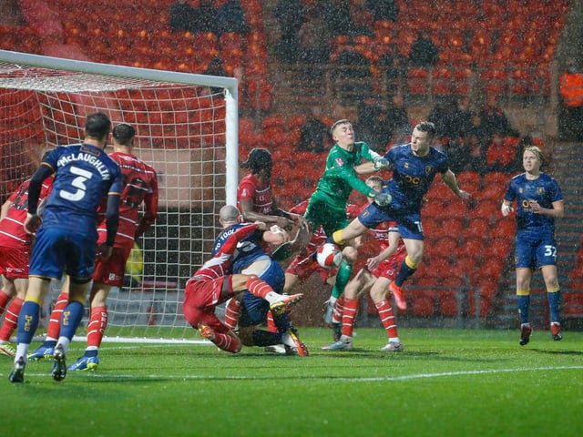Goalmouth action in atrocious conditions during the Emirates FA Cup second round against Doncaster Rovers.