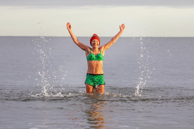 Melinda O'Reilly enjoys the water at Portobello Beach despite freezing temperatures on Christmas day. The annual tradition saw dozens dive into the water just off the coast of Edinburgh.