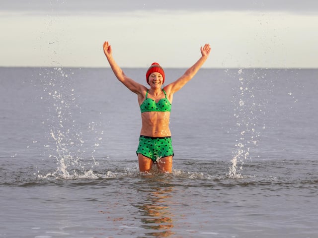 Melinda O'Reilly enjoys the water at Portobello Beach despite freezing temperatures on Christmas day. The annual tradition saw dozens dive into the water just off the coast of Edinburgh.