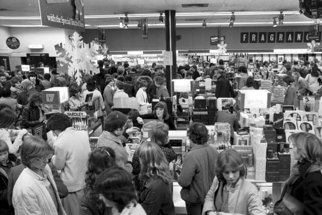 Christmas shoppers in the usual last-minute rush - the cosmetic/perfume department of Princes Street branch of Boots Edinburgh, December 1983.