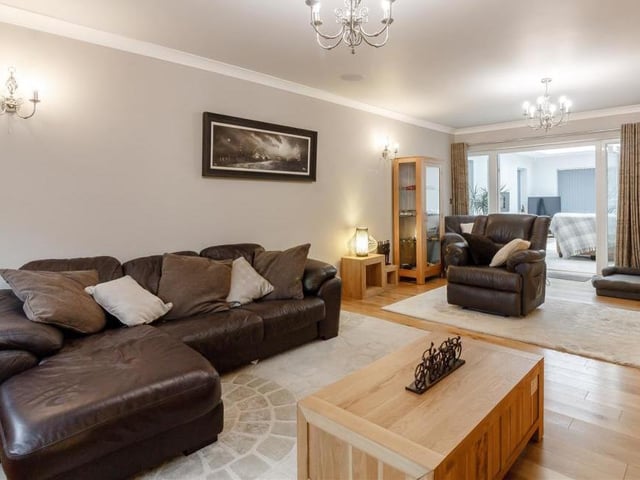 A final look at the large and comfortable lounge, which has a double-glazed window to the front of the property, plus double-glazed French doors that lead to the orangery extension.