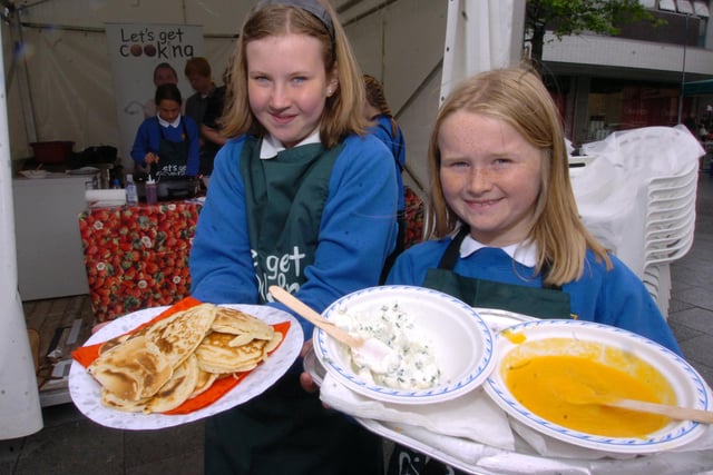 Jess Searby and Hazel Joel with pancakes and toppings in 2011