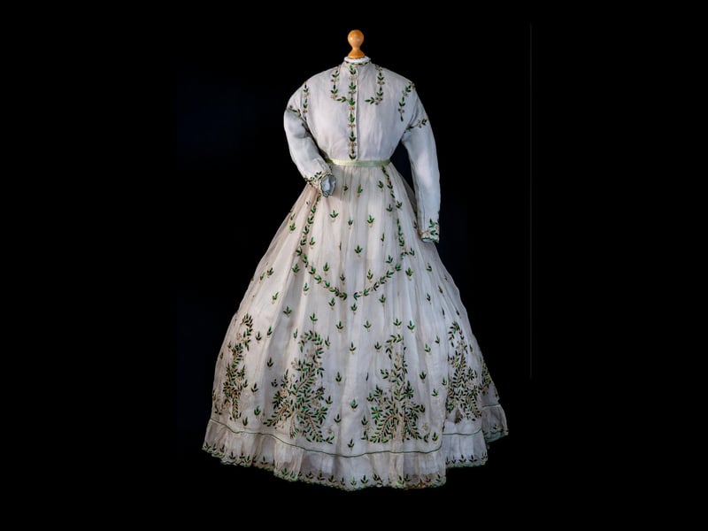 This fine dress speak of emigration, aspiration and Highland links to the Empire. It was made in Madras in 1868 for  Inverness-born Barbara Morrison, the wife of a British Army officer stationed in India. The dress is embellised with silk embroidery and the wings of the jewel beetle.