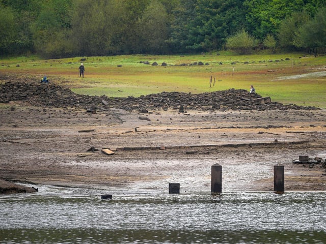 People inspect the ruins of Derwent Village. (Photo by Christopher Furlong/Getty Images)