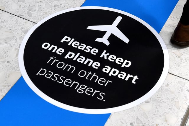 New signage at Edinburgh Airport warns passengers to keep a safe distance from other travellers.