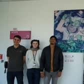 Researchers from NCEFE with one of the pieces of art