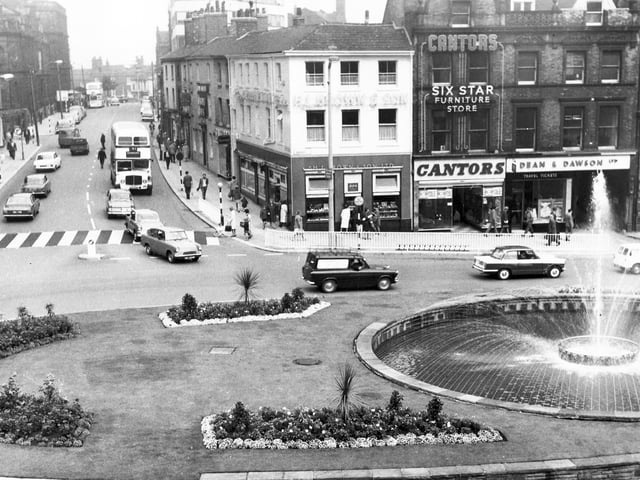 Cars and buses travel along Leopold Street and around the Goodwin Fountain to Fargate on August 10, 1967