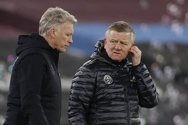 Sheffield United's manager Chris Wilder, right, looks at West Ham's manager David Moyes during an English Premier League soccer match between West Ham and Sheffield United at the London stadium in London, England, Monday Feb. 15, 2021. (John Sibley/Pool via AP)