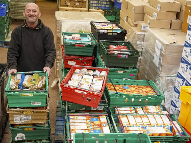 Caretaker and driver Mick Hanley with some of the food donated by Sheffield Telegraph readers at the S6 Food Bank. Picture Scott Merrylees