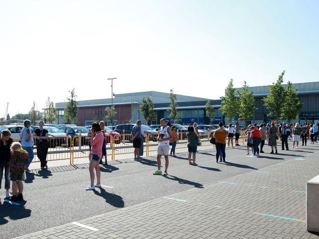 Shoppers in Milton Keynes wait to enter a Primark store at the MK1 Shopping Park.