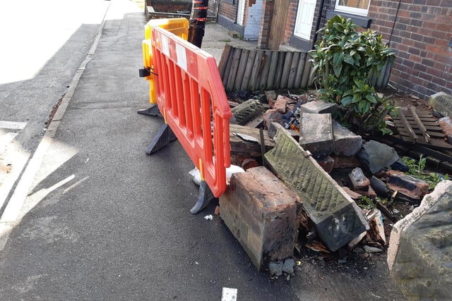 A damaged wall and lamppost on Retford Road