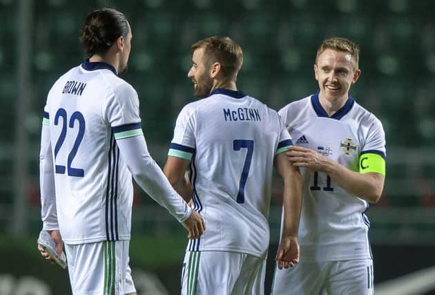 From left: Northern Ireland's Ciaron Brown, Niall McGinn and Northern Ireland's Shane Ferguson celebrates after scoring their side's first goal during the international friendly soccer match between Estonia and Northern Ireland at the A. Le Coq Arena in Tallinn, Estonia, Sunday, Sept. 5, 2021. (AP Photo/Raul Mee)