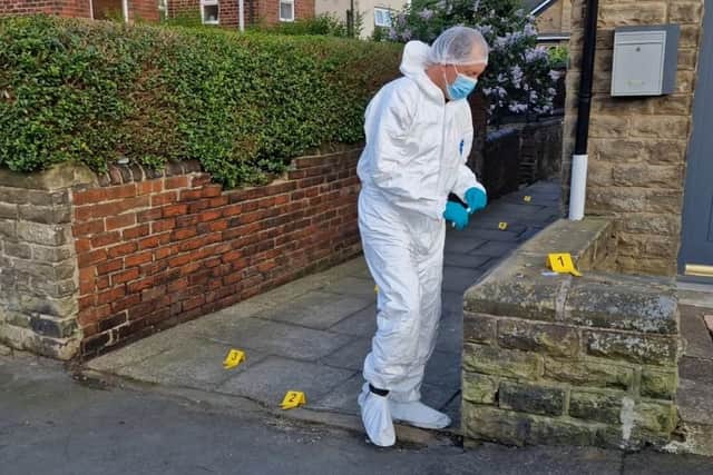 A forensics officer on Mulehouse Road, Crookes.