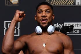 British heavyweight champion boxer Anthony Joshua gestures during his weigh-in at the O2 arena ahead of his bout with Ukraine's Oleksandr Usyk, in London on September 24, 2021. - Anthony Joshua could face his "toughest-ever fight" when he defends the WBA, IBF and WBO heavyweight titles against Oleksandr Usyk in London on Saturday. (Photo by Ben STANSALL / AFP) (Photo by BEN STANSALL/AFP via Getty Images)
