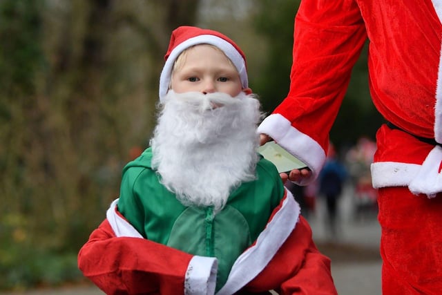 A young runner sporting an impressive Santa beard during the run.