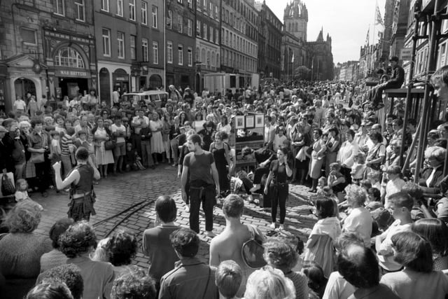 The High Street becomes pedestrian-only as Edinburgh Festival Fringe acts and street performers entertain the crowds in August 1981.