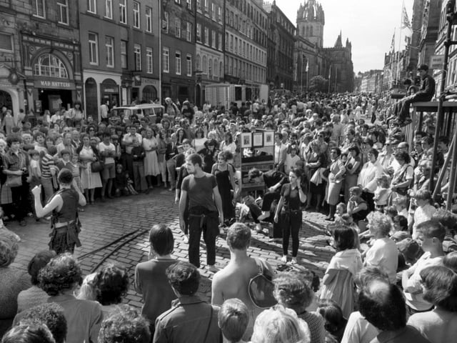 The High Street becomes pedestrian-only as Edinburgh Festival Fringe acts and street performers entertain the crowds in August 1981.