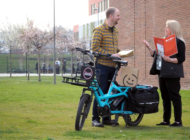 Russell Cutts picking up the Active Practice welcome packs from Tanya Howard at the Advanced Wellbeing Research Centre to deliver by cargo bike