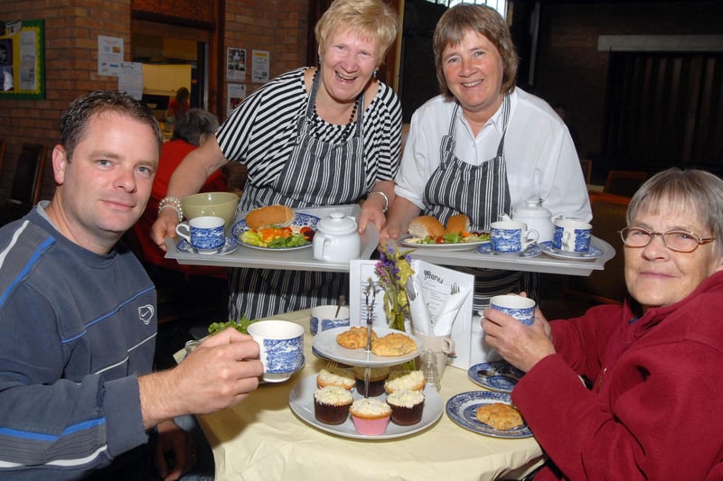 Staff Janet Wix and Bronwen Surgey serve tea, cakes and meals to Tim Bates and his mother Jean in the community café at Mansfield Baptist Church.