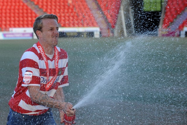 James Coppinger celebrates promotion with a little bit of the bubbly
