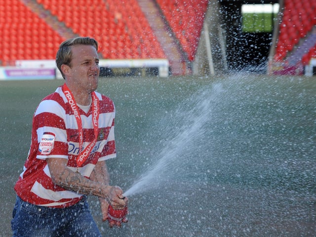 James Coppinger celebrates promotion with a little bit of the bubbly