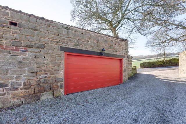 A large lawned area is accompanied by a vegetable garden and seating terrace, while the North Wing's double garage is equipped with an automatic remote control roller shutter door. A doorway also gives access to a good-sized stone-built shed, currently used as a wood store.