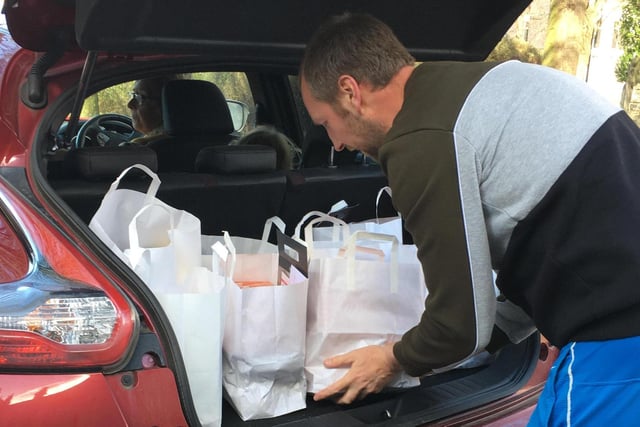 Volunteer Phil Ashford is pictured packing his car with bags of food - he has been helping Age UK Sheffield, which has delivered over 750 essential parcels since lockdown was announced on March 23.