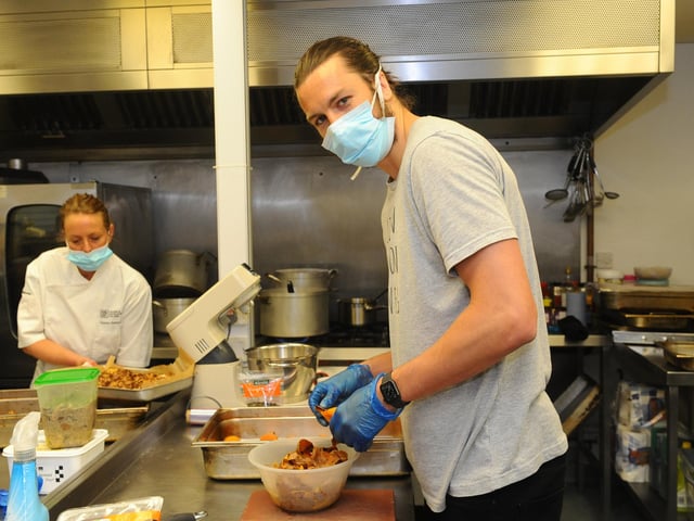 Portsmouth FC players Christian Burgess and Sean Raggett volunteering their time to help provide hot meals to people in the area who are isolated or in need of food.