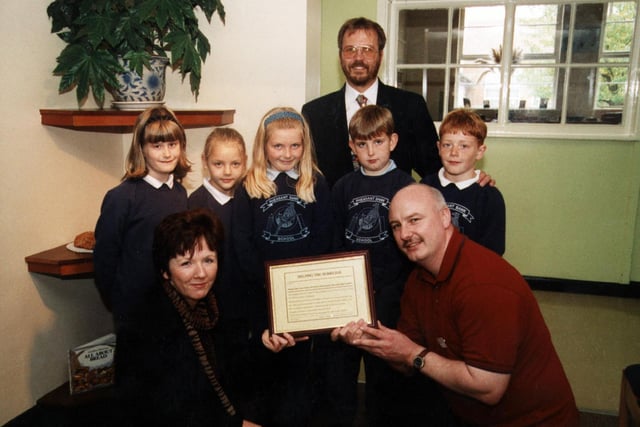 Harvest Fesatival/Food to homeless in 1999.Left-right:  Back: Head Teacher, Mr John Deans.    Middle: Katie Winfrow (8), Rose Newsom (8), Alice Needham (8), Conor Bycroft (8), Louis Egan (8)   Front: Maureen Beirne, Health Visitor for the homeless, Derek Taylor, Doncaster Healthcare NHS Trust.