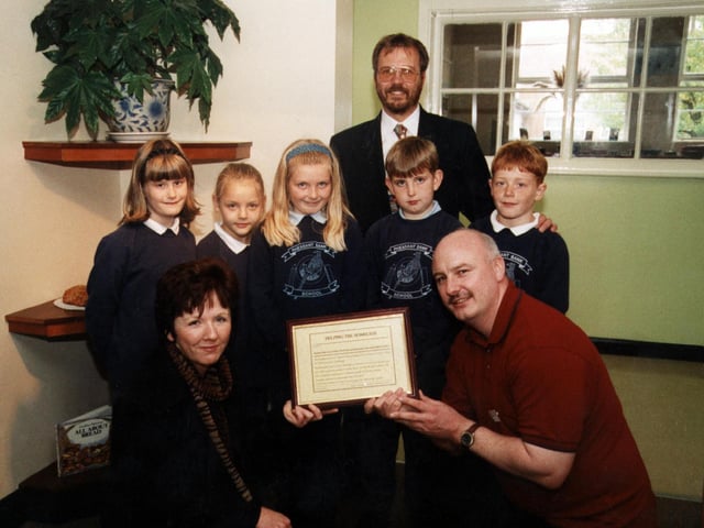 Harvest Fesatival/Food to homeless in 1999.Left-right:  Back: Head Teacher, Mr John Deans.    Middle: Katie Winfrow (8), Rose Newsom (8), Alice Needham (8), Conor Bycroft (8), Louis Egan (8)   Front: Maureen Beirne, Health Visitor for the homeless, Derek Taylor, Doncaster Healthcare NHS Trust.