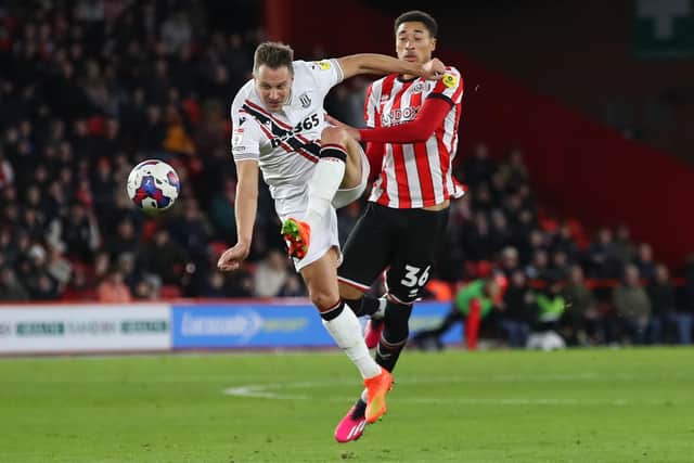 Sheffield United youngster Daniel Jebbison proves a handful for former Blades defender Phil Jagielka, now of Stoke City: Lexy Ilsley / Sportimage
