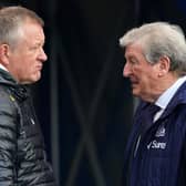 Chris Wilder talks to Crystal Palace's former England manager Roy Hodgson 