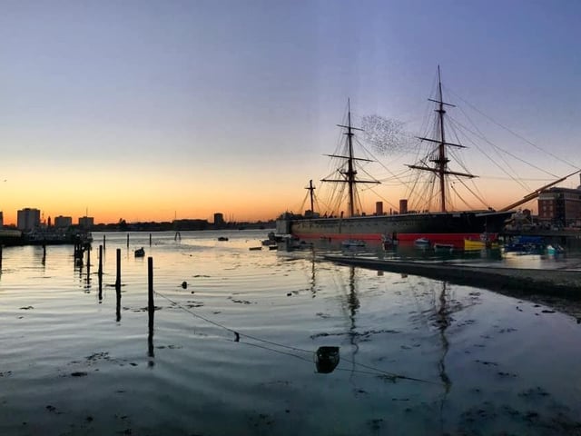 We leave you with this wonderfully calm view of HMS Warrior. The harbour is so still, as a murmuration of starlings fly between the ship's masts.