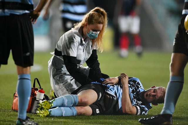 Shona Tait treats Nicky Low's injury.