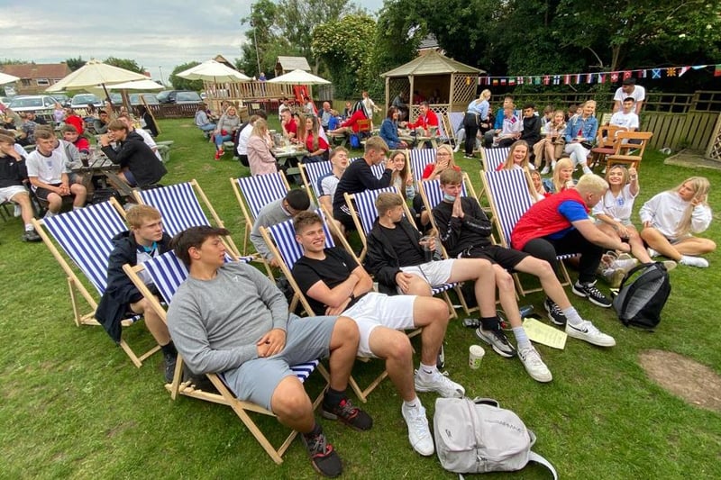 Fans take their seats in the garden of the Raby Arms.