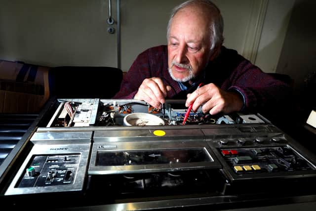 Repair Cafe at Heeley City Farm: Repairer Peter checking an old VHS recorder