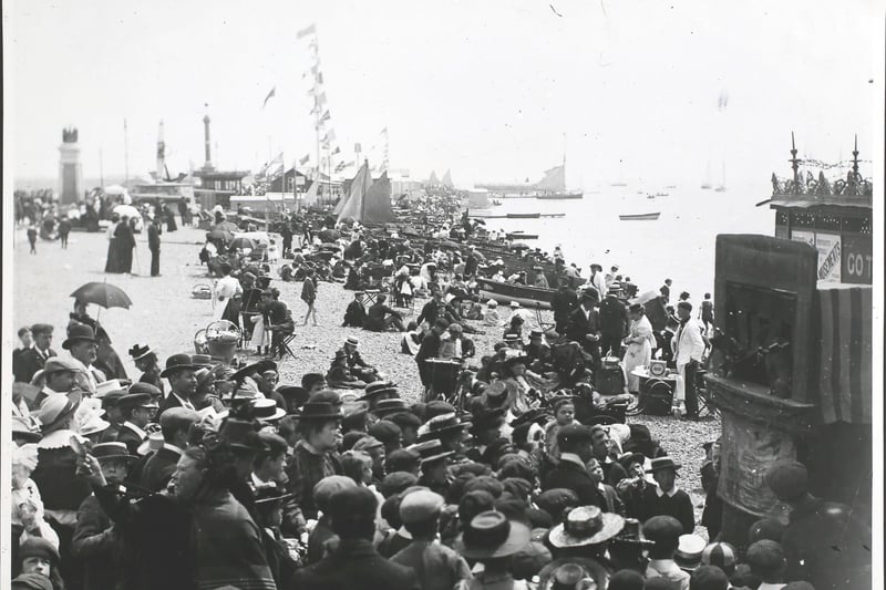 A Punch and Judy show on the beach at Southsea in the1890s. Photo by F. J. Mortimer/Hulton Archive/Getty Images