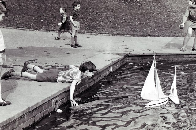 Children make the most of the sun and Easter holidays at the Firth Park model boat lake, April 1969