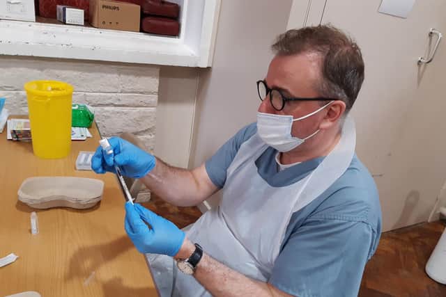 File picture shows Sheffield GP Tom McAnea Covid preparing a Covid vaccination. Sheffield is now said to have one person in 35 testing positive for the virus