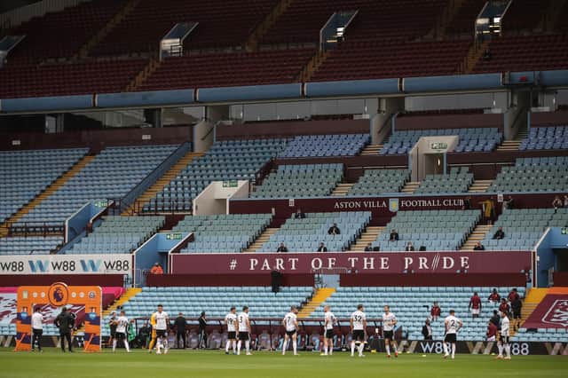 Sheffield United's players warm up next to empty stands prior to the    English Premier League football match between Aston Villa and Sheffield United at Villa Park   (Photo by CARL RECINE/POOL/AFP via Getty Images)