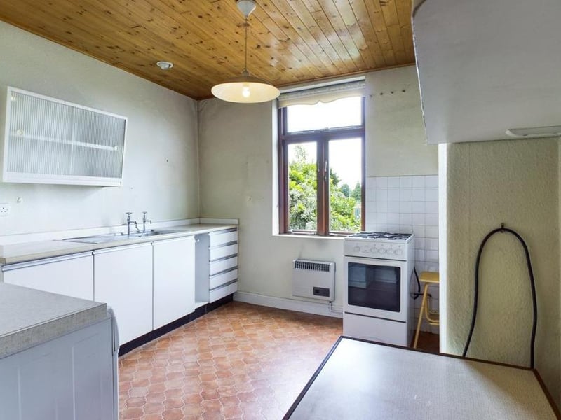 First floor kitchen - Single glazed timber framed window to the rear elevation, inset sink with pillar taps, wall mounted gas heater, cupboard housing the hot water boiler, plumbing for washing machine and power points.