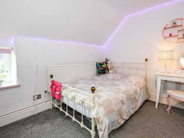 The second of five bedrooms is cute and comfortable. It has a uPVC double-glazed window to the front of the property.