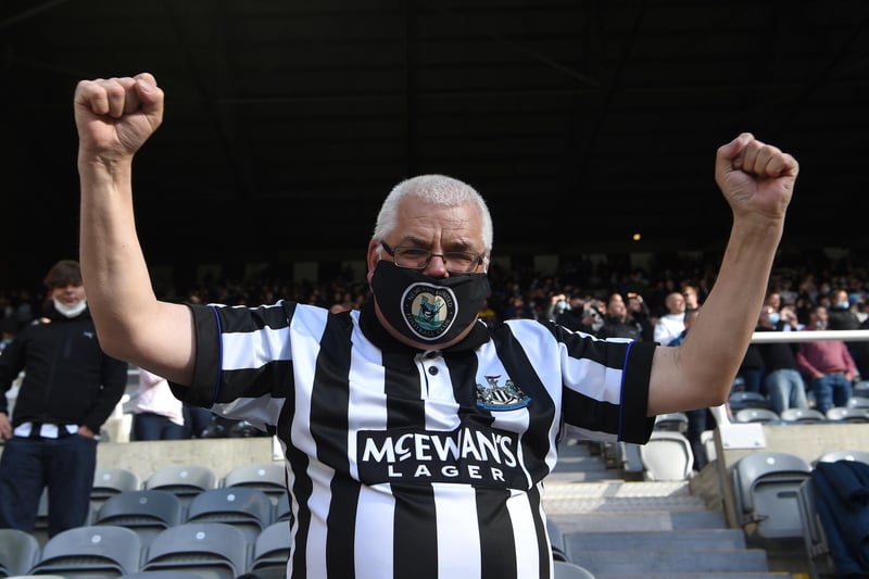 A Newcastle fan wearing a Newcastle club badge face-covering reacts as the players enter the fray during the Premier League match between Newcastle United and Sheffield United at St. James Park.