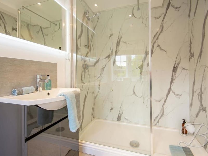 More en suite facilities for one of the bedrooms. Guests will love the modern suite, fitted with a vanity unit and walk-in shower.