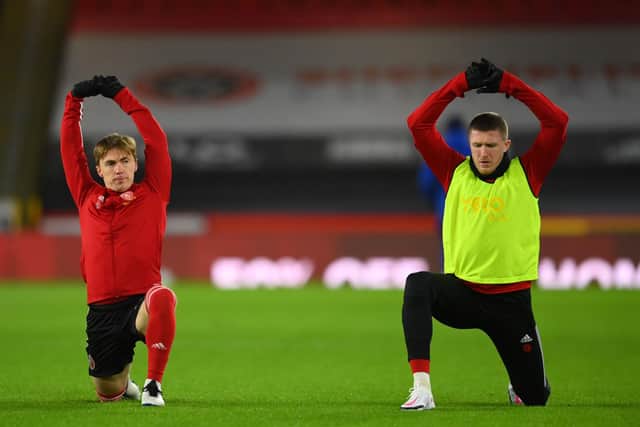 Sheffield United's English midfielder Ben Osborn (L) and Sheffield United's English midfielder John Lundstram (R) warm up ahead of the English Premier League football match between Sheffield United and Chelsea at Bramall Lane in Sheffield, northern England on February 7, 2021: CLIVE MASON/POOL/AFP via Getty Images