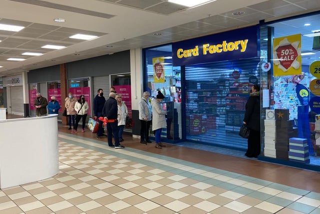 Shoppers waiting outside Card Factory in Middleton Grange Shopping Centre.