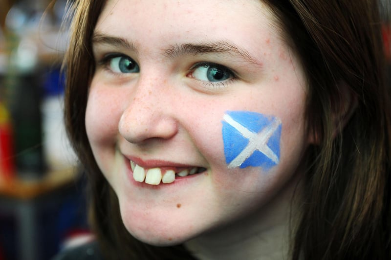 As well as flags and strips, many youngsters sported saltires on their faces 
(Pic: Michael Gillen)