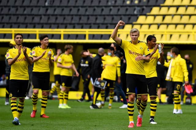 Dortmund's Norwegian forward Erling Braut Haaland (C) celebrates with his teammates their victory 4:0 after the German first division Bundesliga football match BVB Borussia Dortmund v Schalke 04 on May 16, 2020 in Dortmund, western Germany as the season resumed following a two-month absence due to the COVID-19 pandemic. (Photo by MARTIN MEISSNER/POOL/AFP via Getty Images)